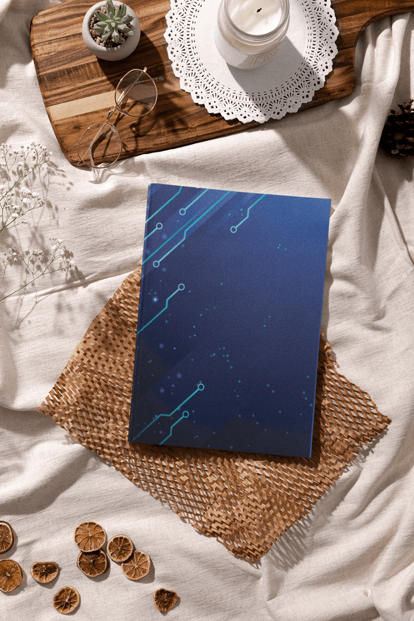 Cyber blue Crypto Trading Journal on a textured mat, surrounded by decorative elements and a candle.