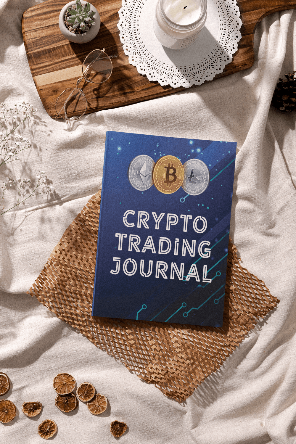 Cyber blue Crypto Trading Journal on a table, featuring cryptocurrency symbols and a cozy setting.