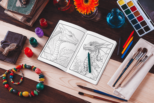 Open coloring book with dragon designs, colorful pencils, paint, and craft supplies on a table.