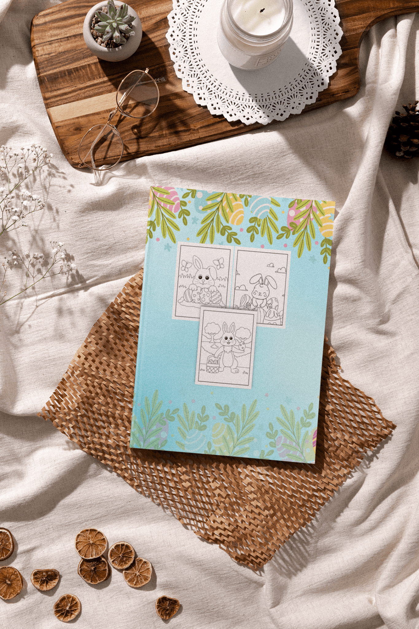 Easter coloring book for kids placed on a rustic table with decorative items and a candle in a cozy setting.