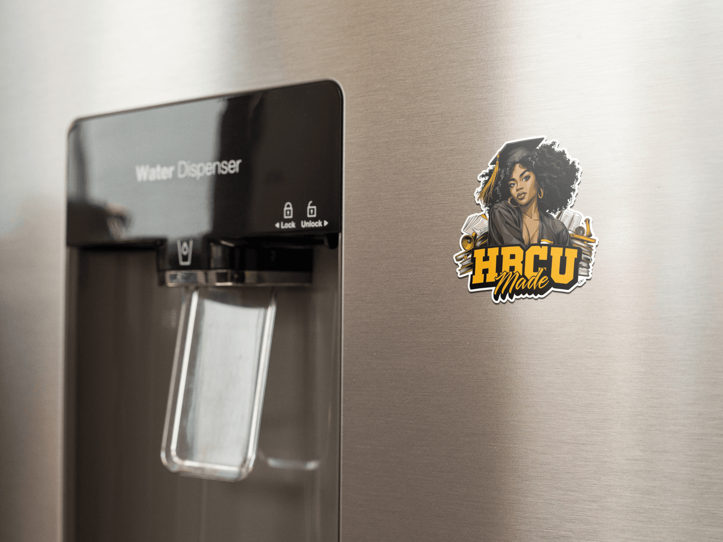 HBCU Made sticker on a stainless steel refrigerator by the water dispenser, showcasing vibrant design.