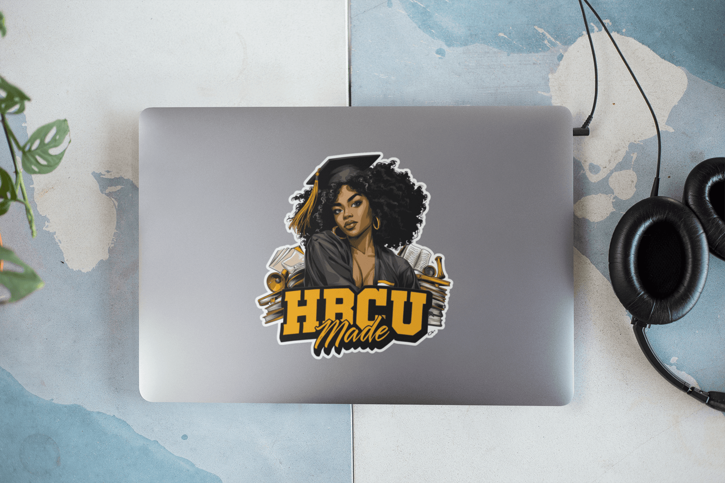 HBCU Made sticker on a laptop cover featuring a stylish, confident woman with curly hair.
