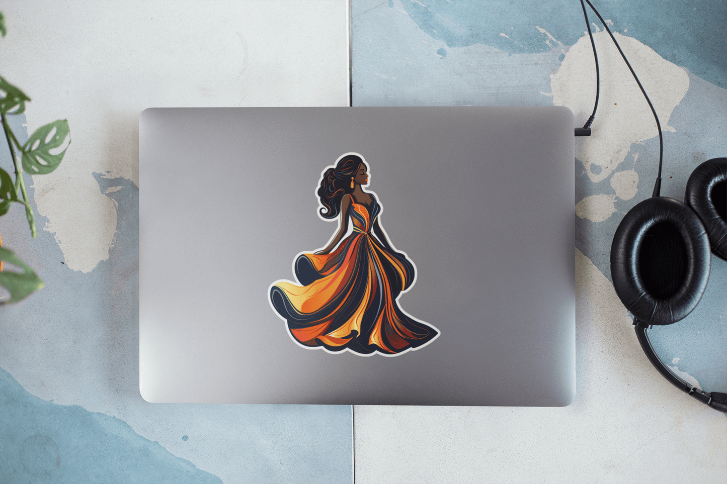 Colorful Midnight Elegance sticker on a laptop, showcasing a stylish dress design.