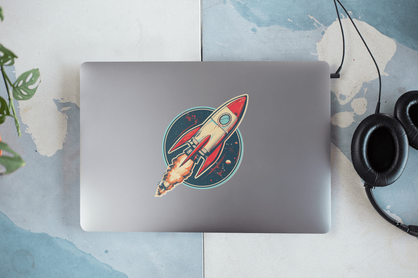 Colorful Atomic Age spacecraft sticker on a laptop, showcasing vibrant design and personality.