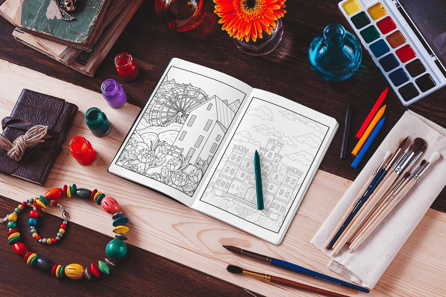 Coloring book open to detailed home illustrations, surrounded by art supplies and colorful beads for a creative vibe.