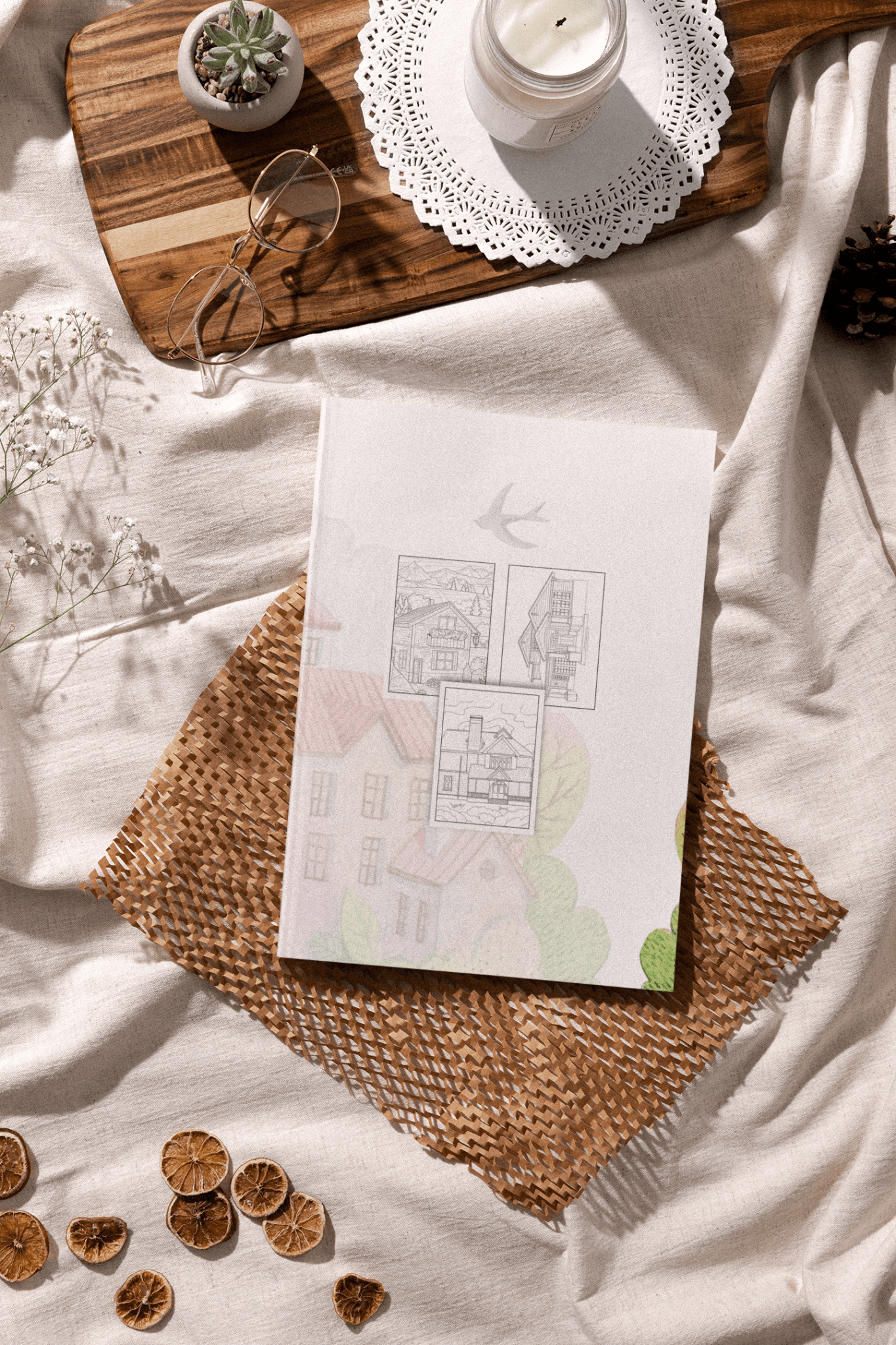 Relaxing Homes and Buildings Adult Coloring Book displayed on a cozy linen background with natural decor.