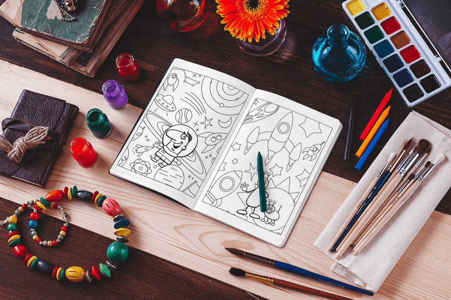 Space and Planets Coloring Book open with colorful art supplies and designs, perfect for creative kids.