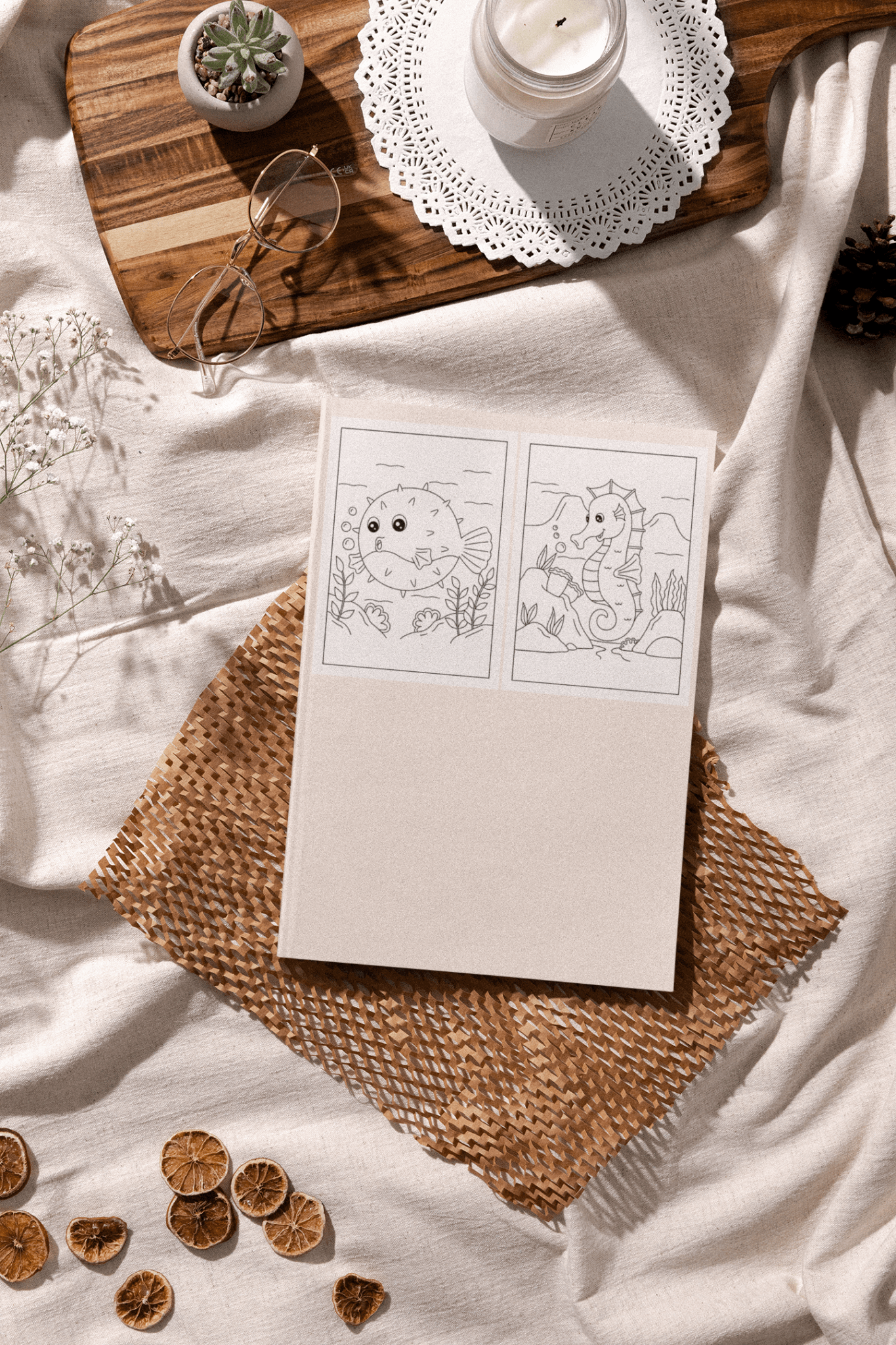 Super Sea Animals Coloring Book on a woven mat with ocean-themed coloring pages and decorative items.