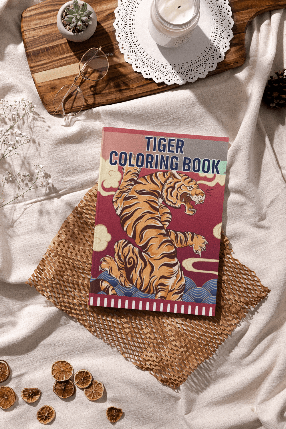 Tiger Coloring Book cover displayed on a cozy surface with decorative elements for relaxation and stress relief.