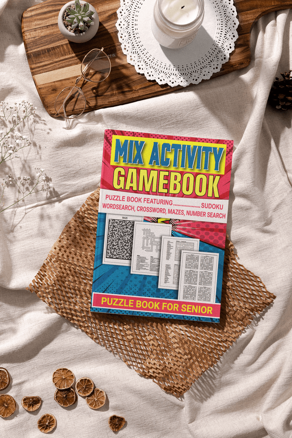 Mix Activity Gamebook for seniors featuring puzzles like Sudoku, word search, crosswords, and mazes on a cozy table.