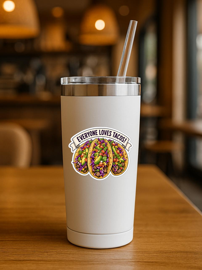 Mockup showing the Everyone Loves Tacos! sticker design on the front of a white tumbler.