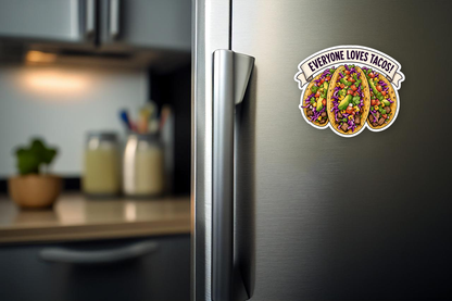 Mockup showing the Everyone Loves Tacos! sticker design on a stainless-steel refrigerator door.