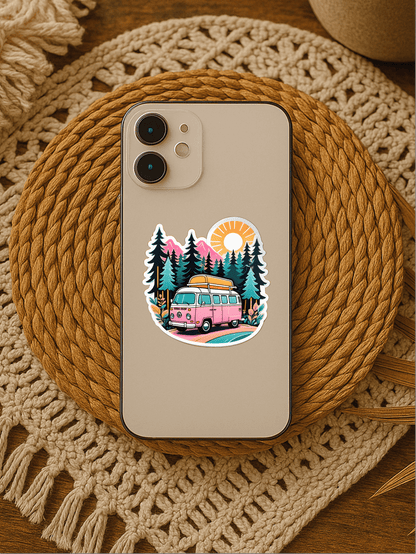 Chill Vanlife Sticker on a phone featuring a colorful van and trees design, sitting on a woven mat.