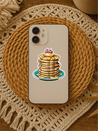 Cherry on the top Pancake Stack Vinyl Sticker on a phone case placed on a woven coaster.