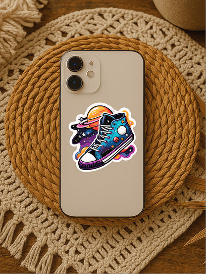 Cosmic Kicks vinyl sticker featuring retro sneakers and space elements on a smartphone.