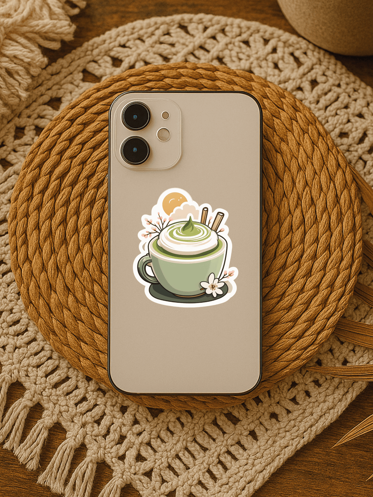 Matcha Vibes & Cozy Reads Vinyl Sticker on a phone within a rustic woven mat.