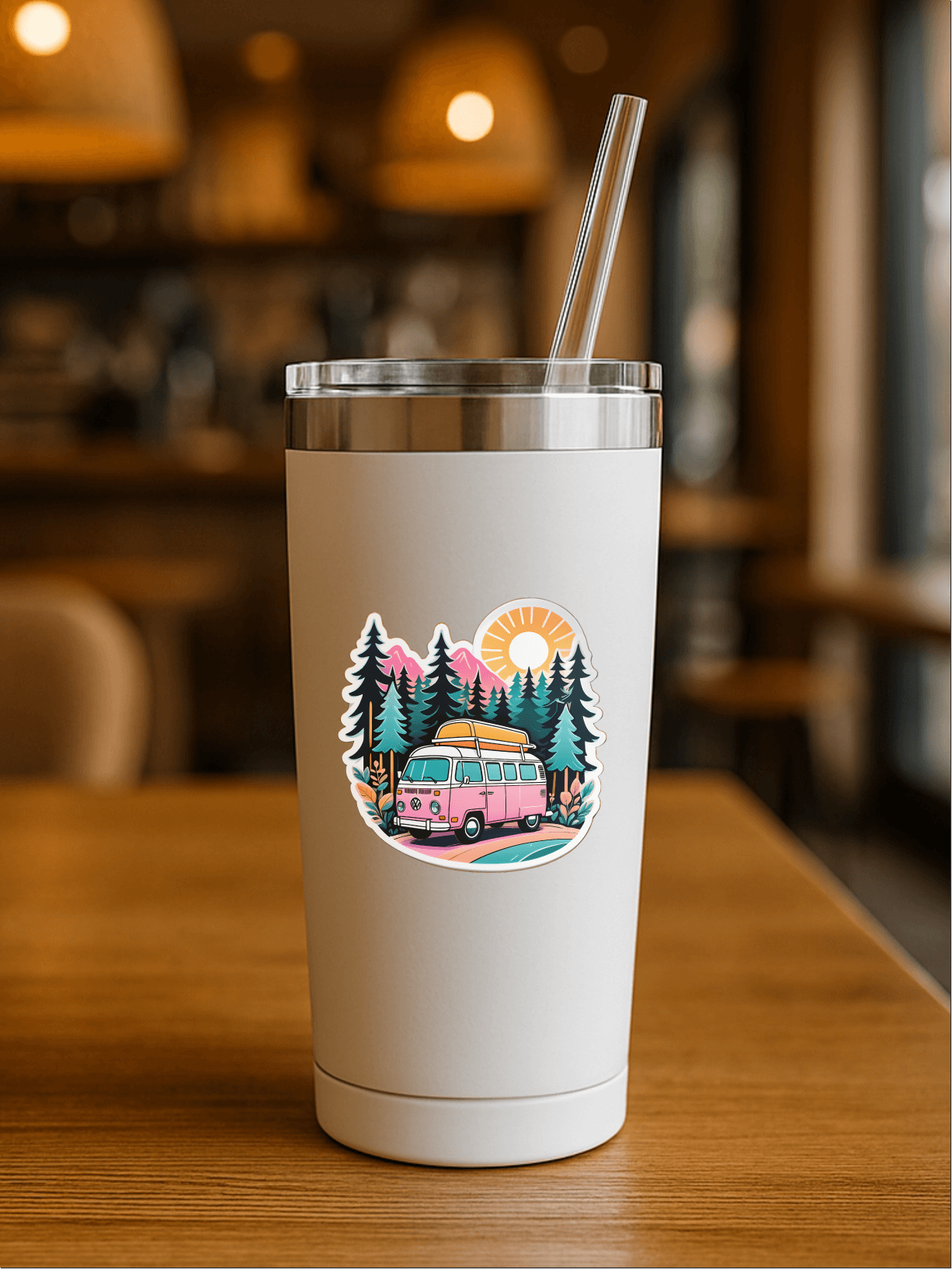 Chill Vanlife Sticker on a stylish tumbler with a vibrant van and nature design in a cozy café setting.