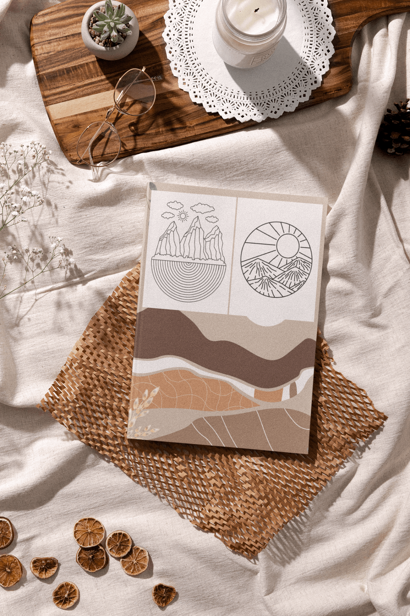 Minimalist Boho Adult Coloring Book displayed on textured fabric with nature-inspired designs.