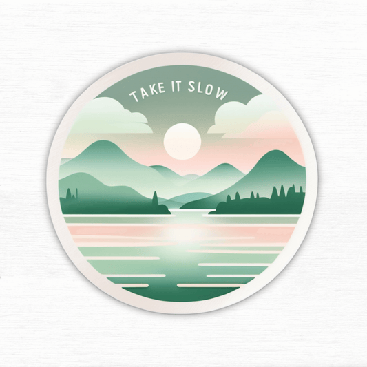 Serenity: Calming Flow Affirmation Vinyl Sticker with soothing landscape and "Take It Slow" text